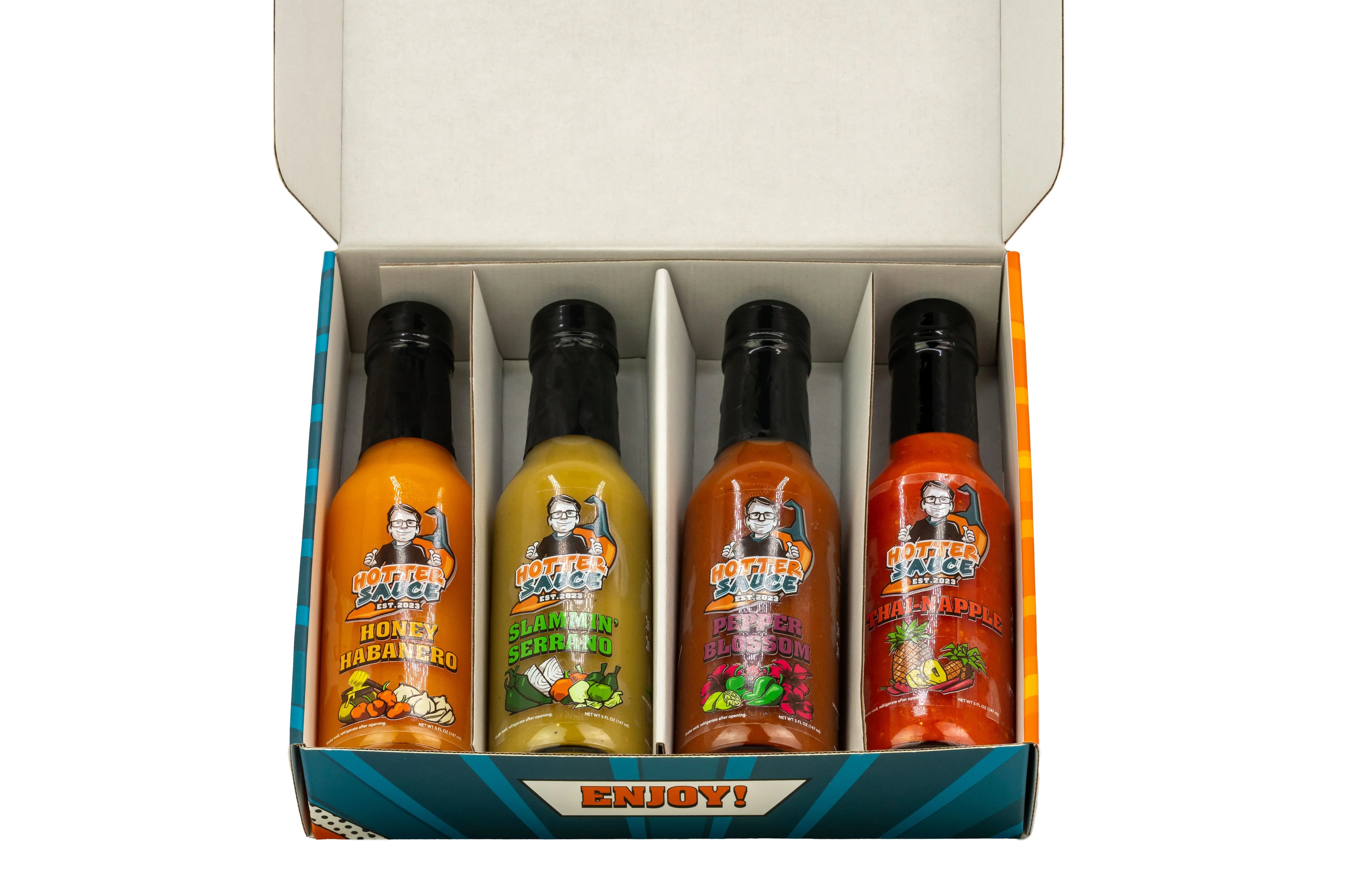 Four hot sauce bottles in a box with labels and a 'Enjoy!' text on a white background.