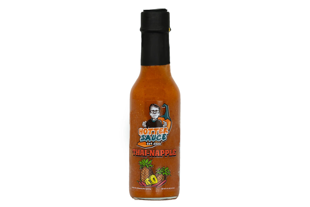 Thai apple hot sauce bottle with branding on a white background